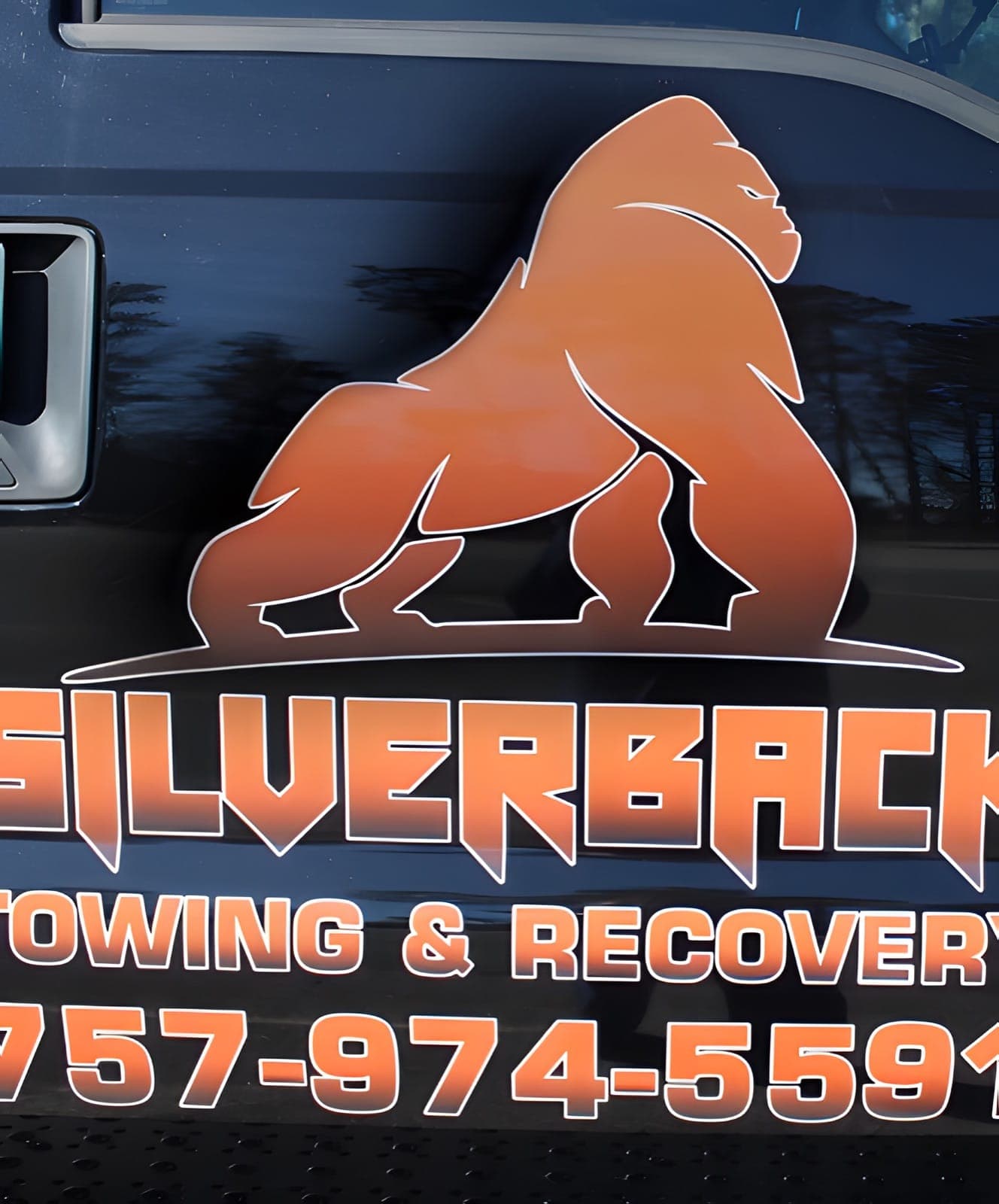 The Silverback gorilla decal and phone number on the tow truck’s driver door