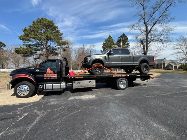 Gray Ford Raptor strapped on the Silverback flatbed