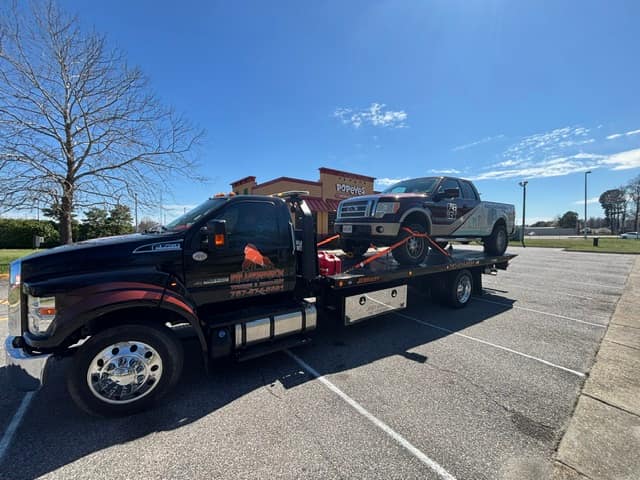 Gray pickup truck on the Silverback flatbed in a parking lot