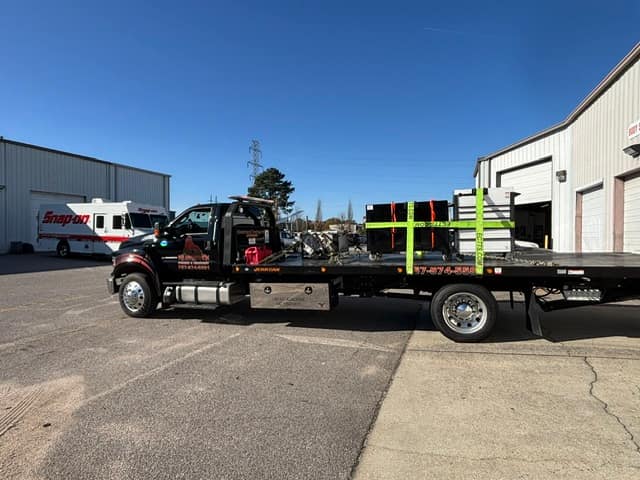 Palletized cargo strapped down on the Silverback rollback at a warehouse